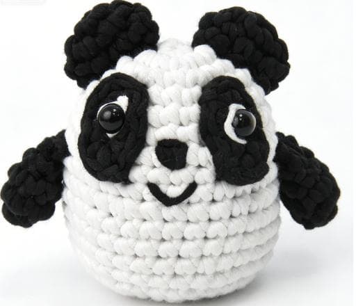 Handmade chubby black and white panda crochet stuffed animal toy, perfect as a cute desk pet or soft plush gift.