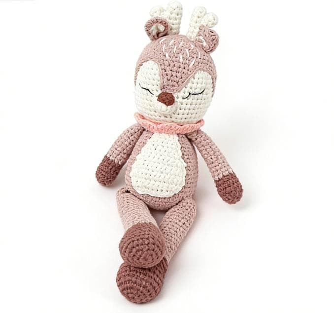 Handmade crochet sleeping fawn stuffed animal sitting inside a black premium Crochetlink gift bag.