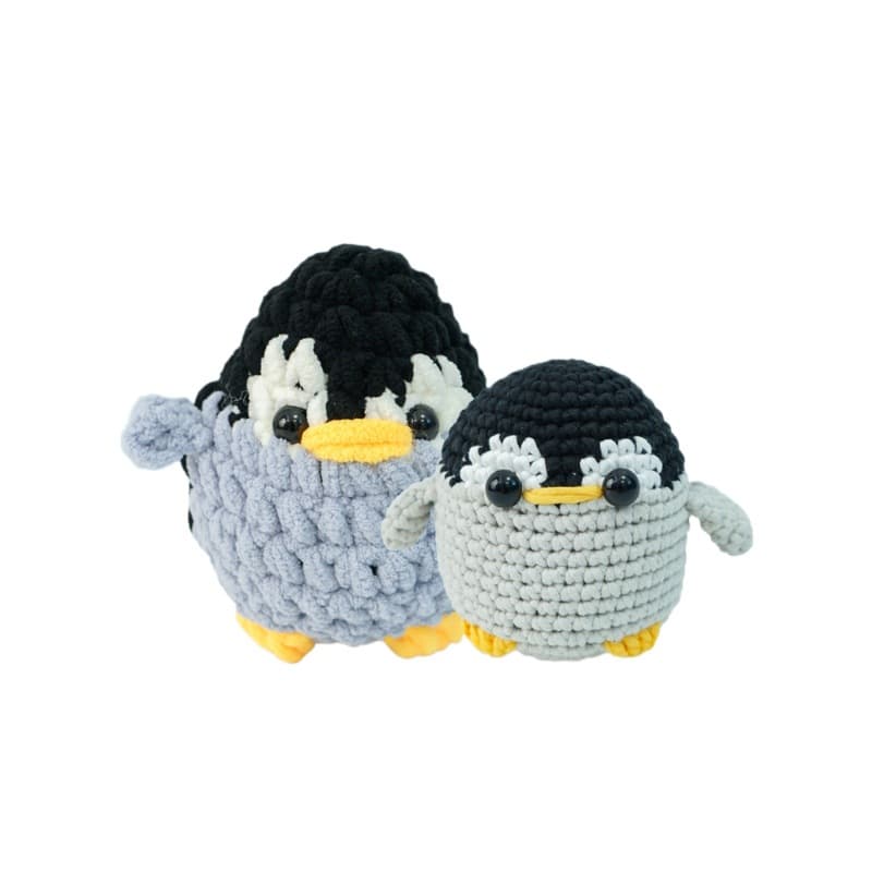 Finished handmade crochet penguin toys from CrochetLink. Soft, egg-shaped penguin stuffed animals with black safety eyes, ready for gifting.