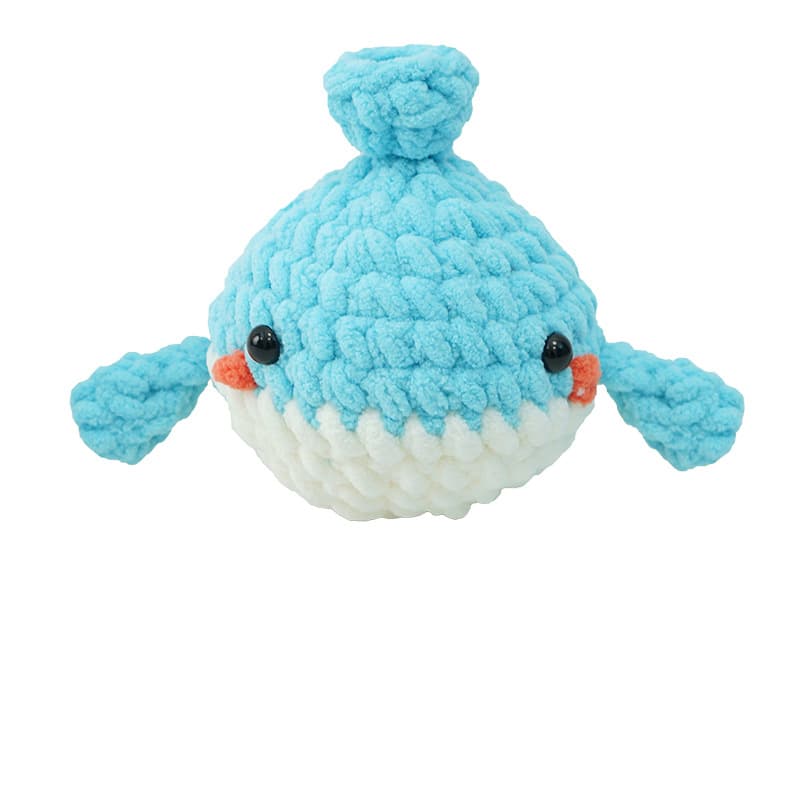 Finished handmade crochet whale toy. A soft, egg-shaped blue ocean plush animal with black safety eyes, ready for gifting
